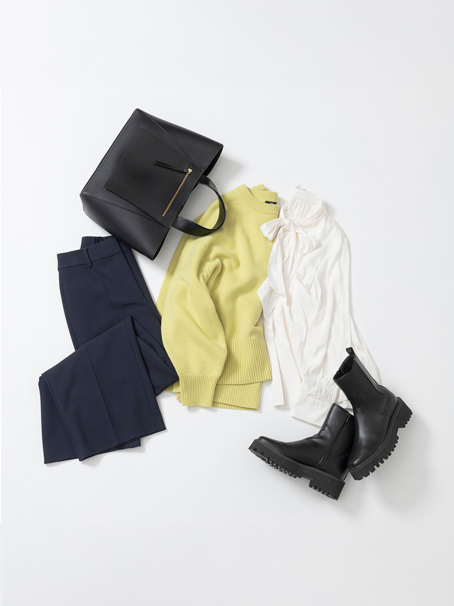 イエローのニットとボウタイブラウスを重ね着したコーデ